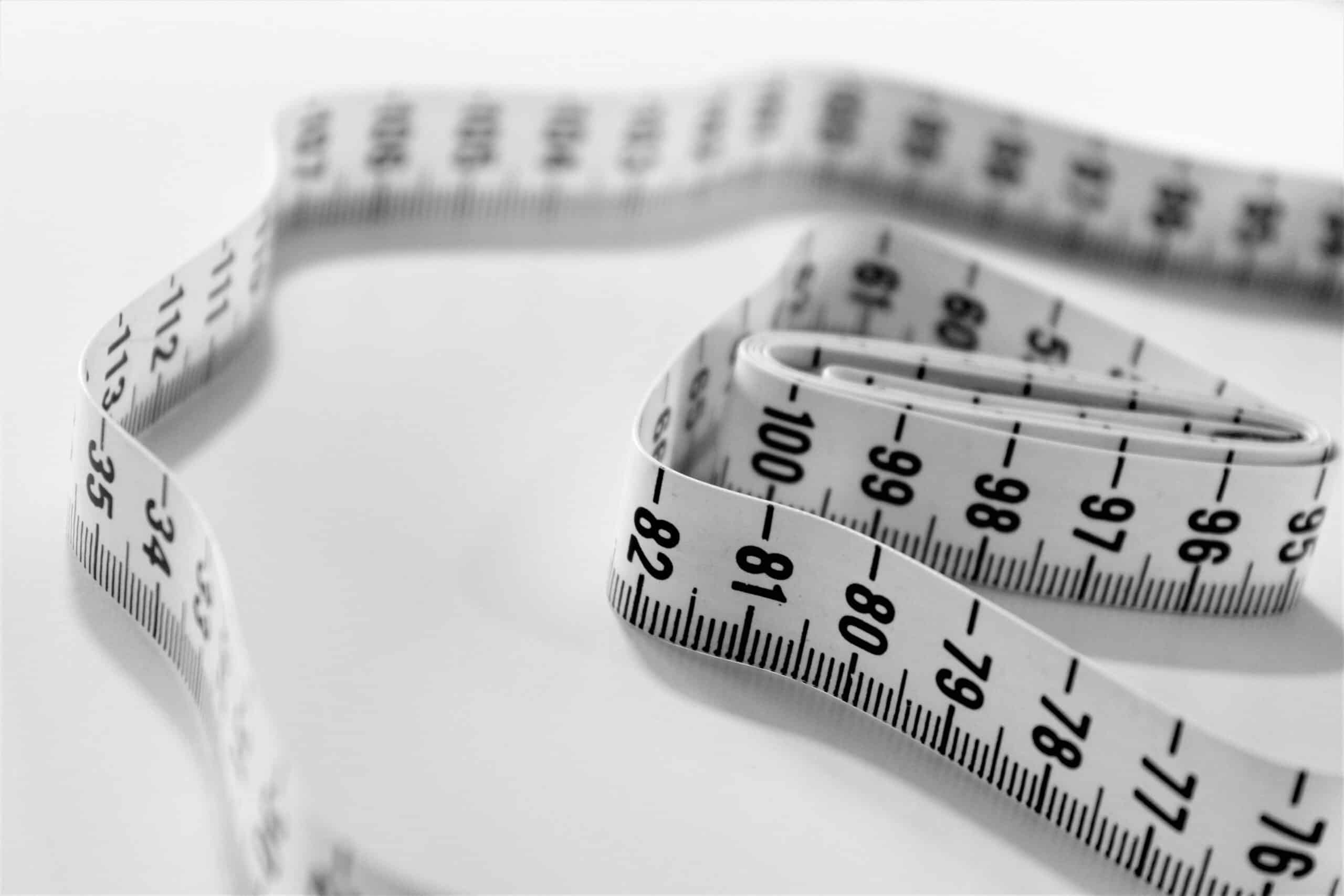 Measuring tape on a white table.
