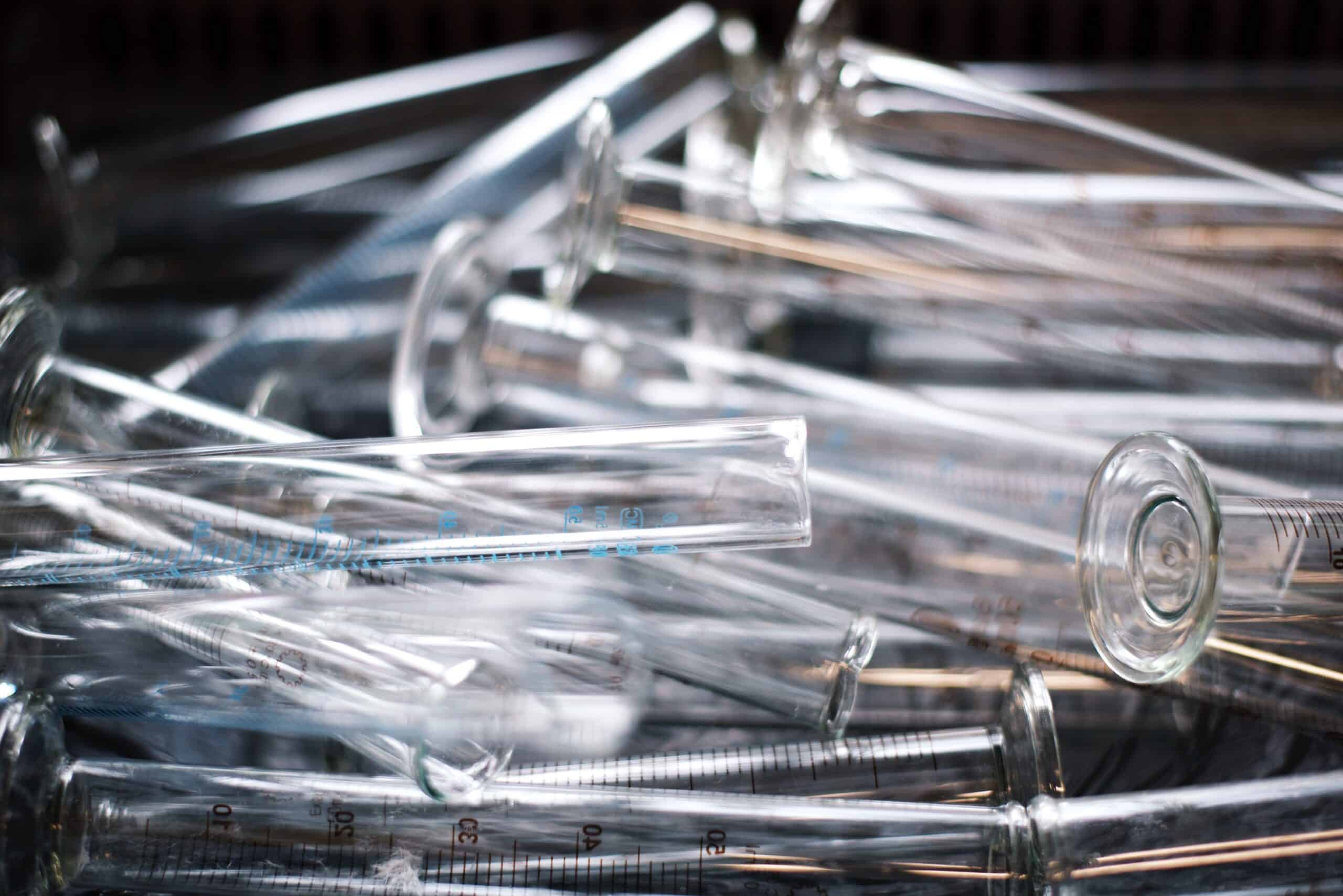 Pile of clear vials with black background.
