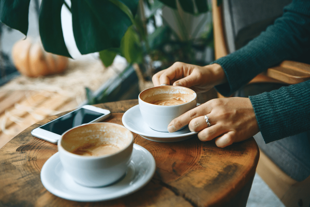 A pair of hands grips a coffee mug.