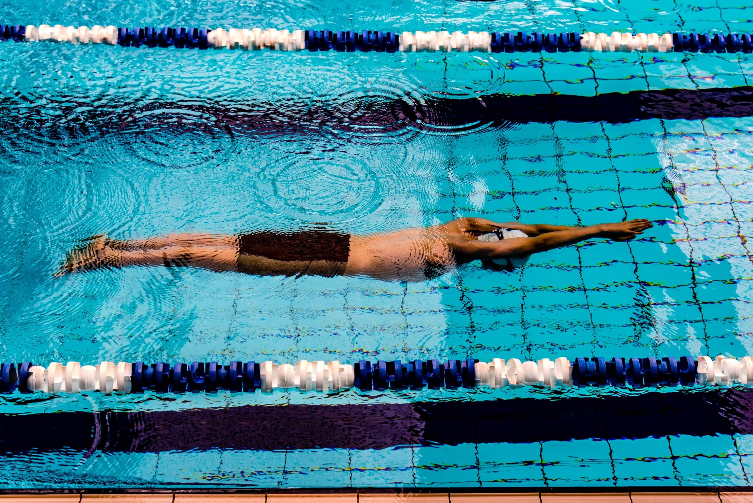 Man swimming in lap pool.