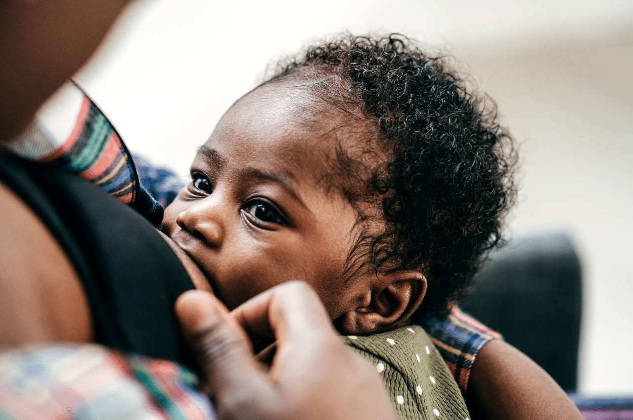 Close-up of baby's face while breastfeeding.
