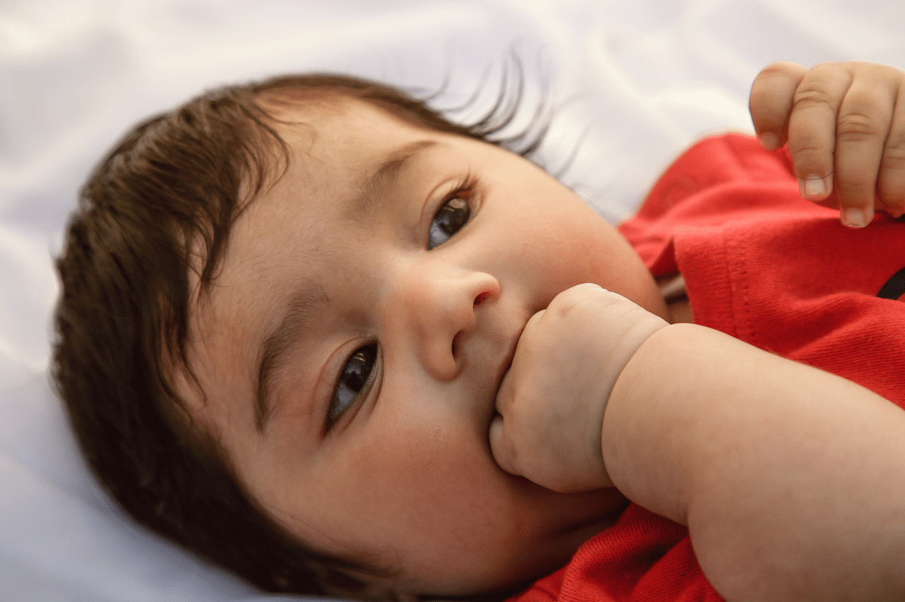 Baby with fist in mouth