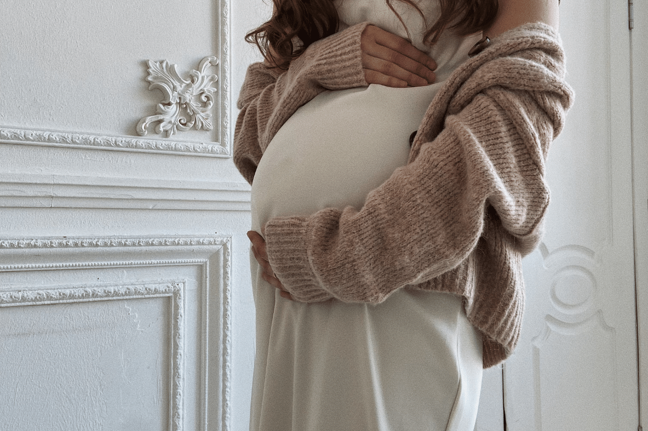 an image of a pregnant woman holding her stomach