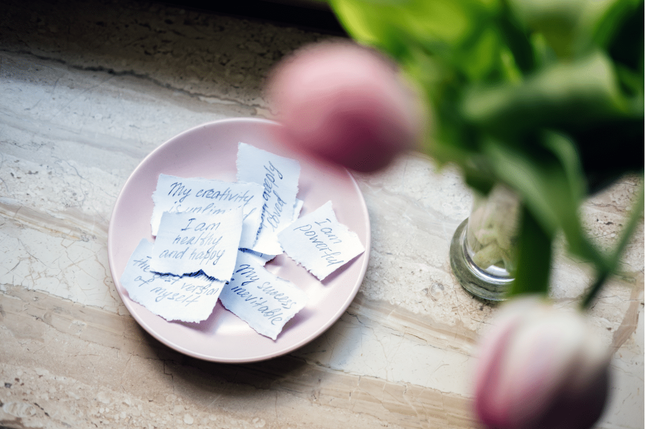 a bowl filled with handwritten positive notes of affirmation