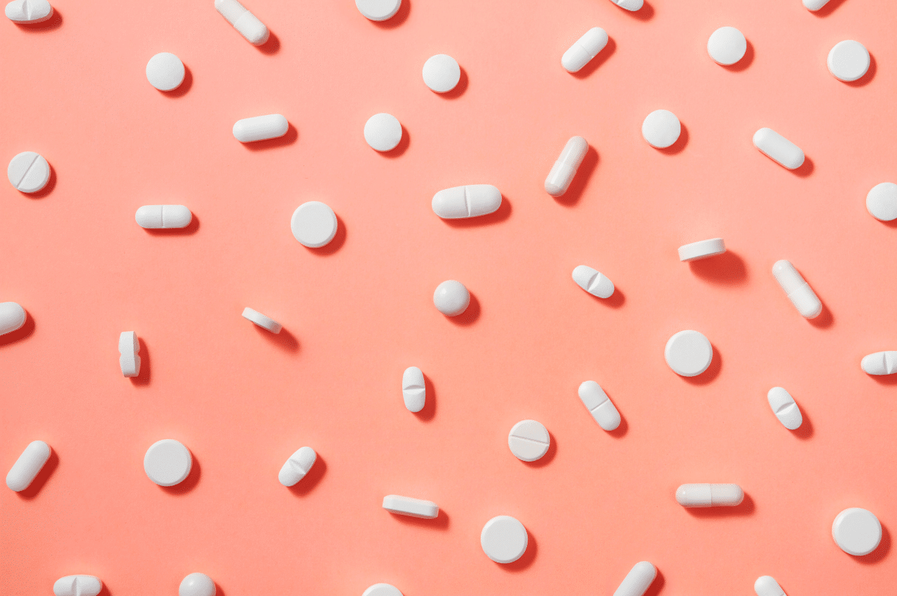 white pills on pink background