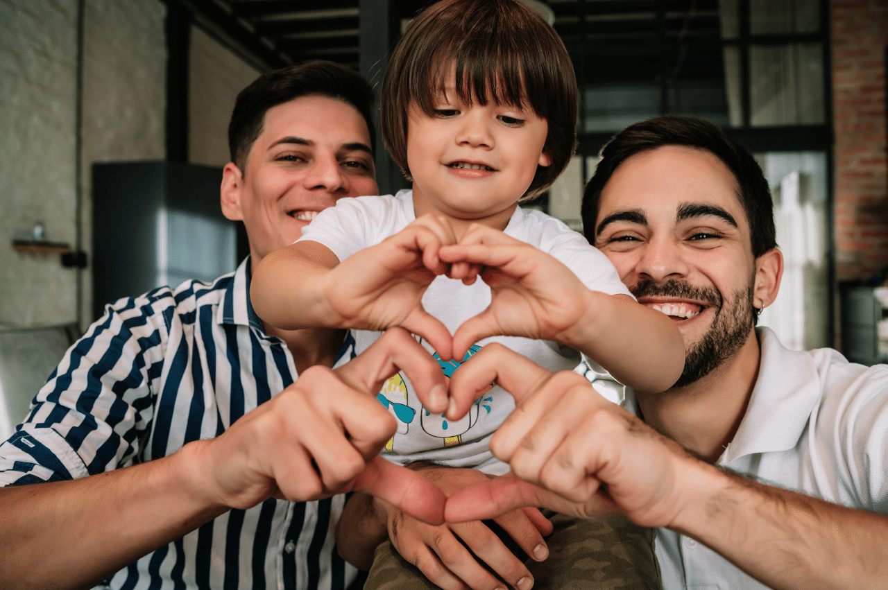 Toddler making the shape of a heart with their hands