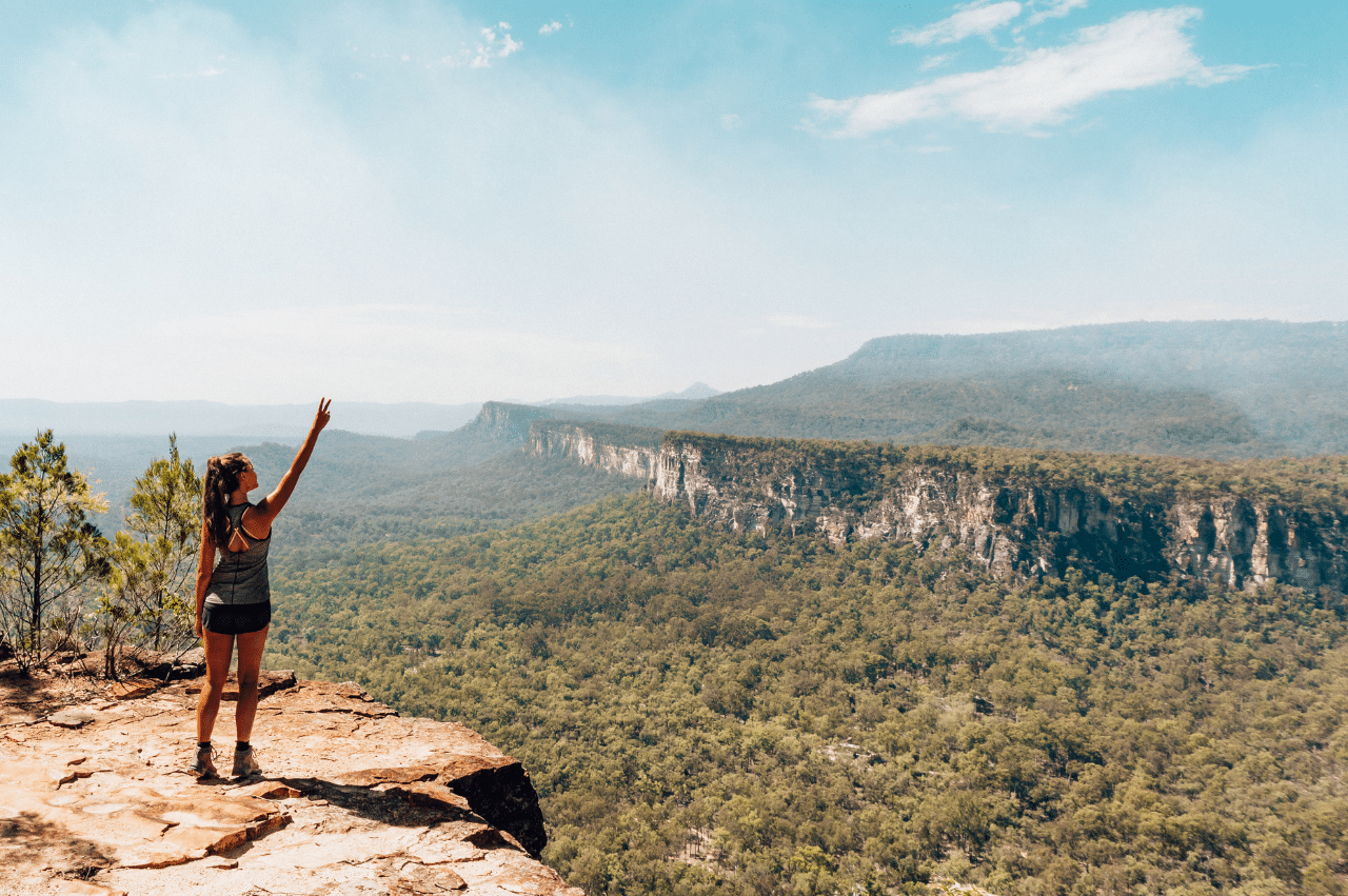 Woman on at top of a cliff