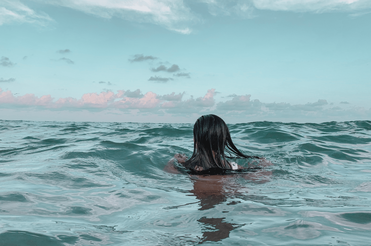 Person neck deep in ocean water