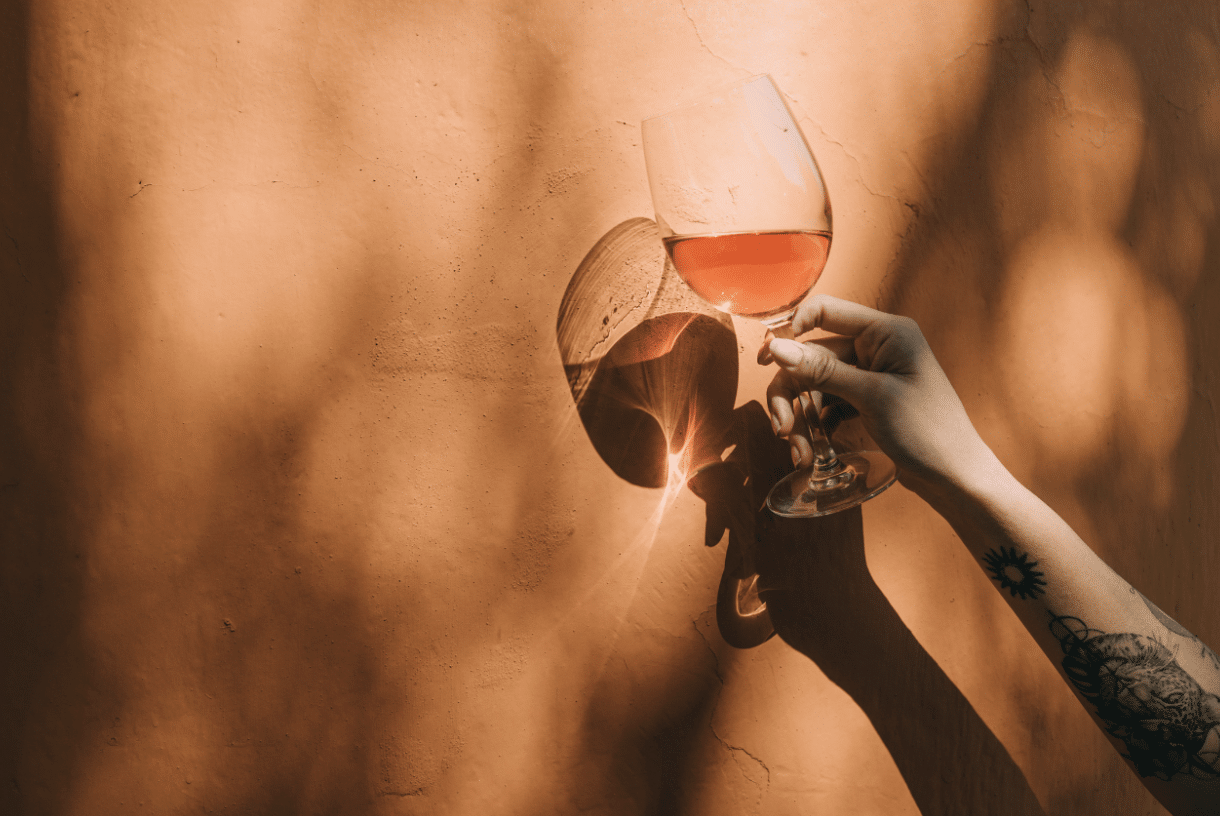 Hand holding up a glass of wine