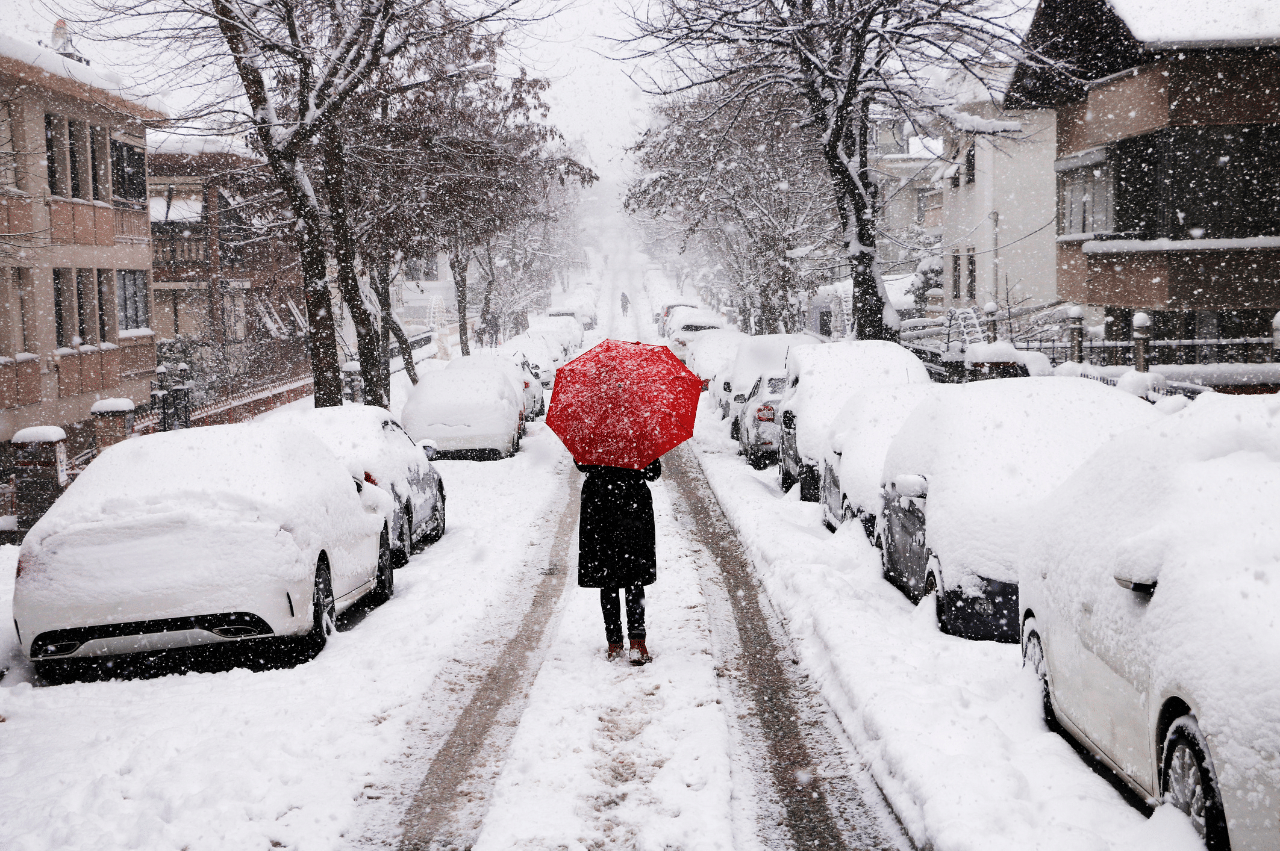 Person walking through a snow covered street