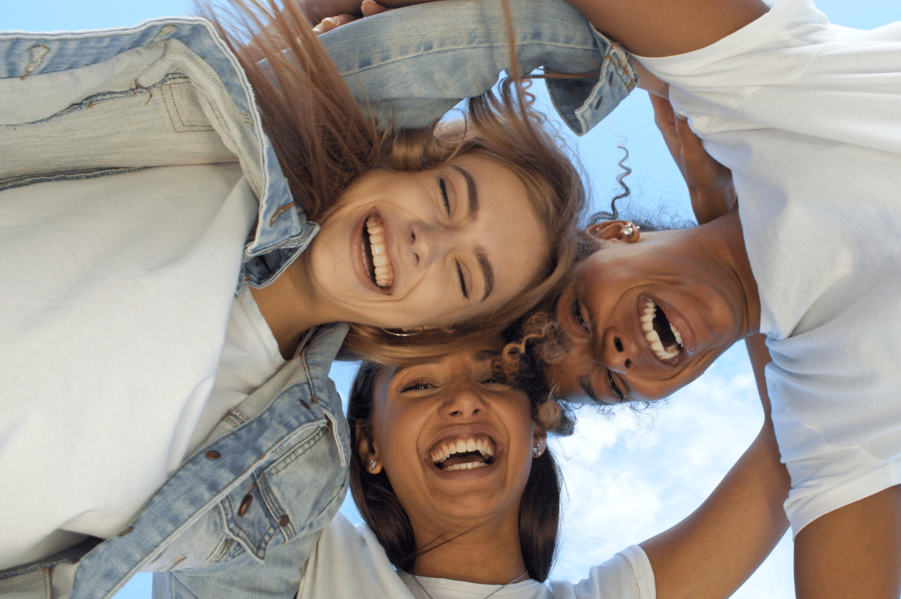 Photo of three women in a huddle