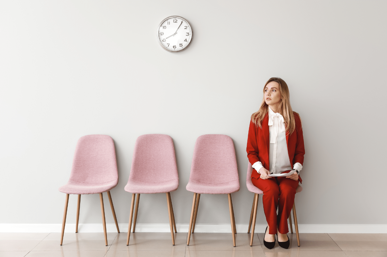 Photo of a woman sitting on a pink chair