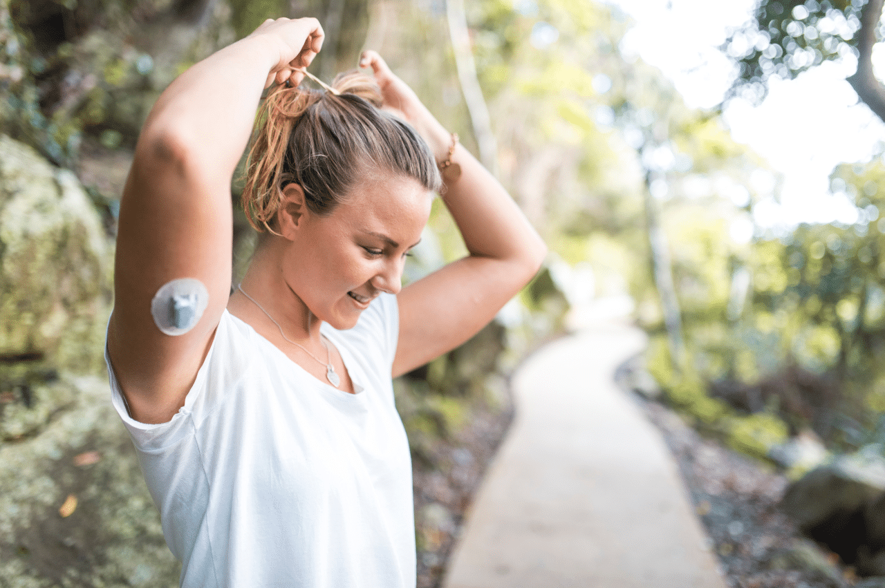 Photo of a woman putting her hair up to prepare for a run