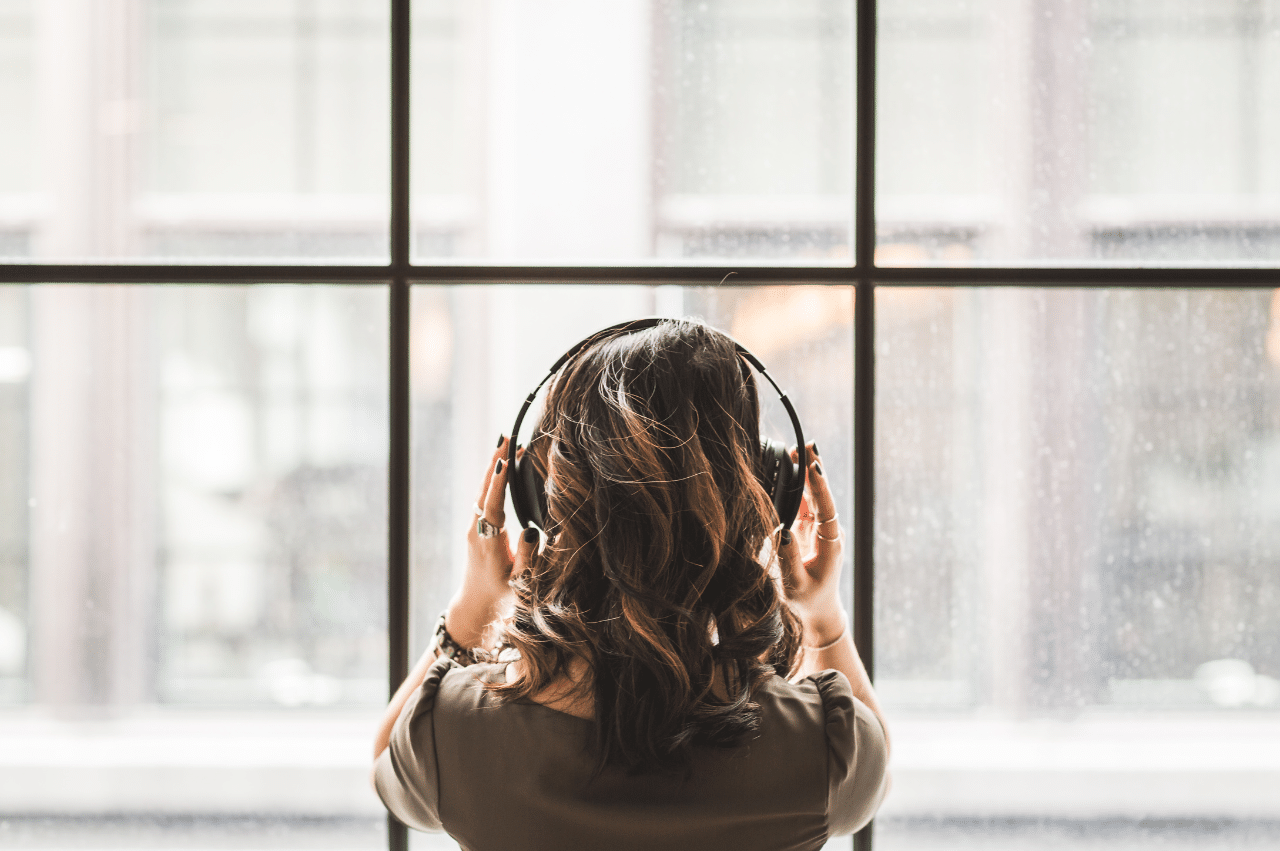Photo of a woman looking out of a window