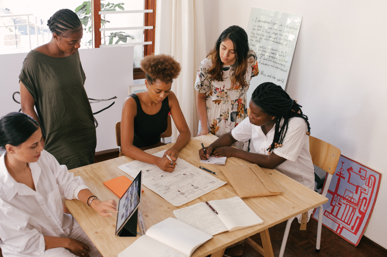 Photo of women having a meeting around a table