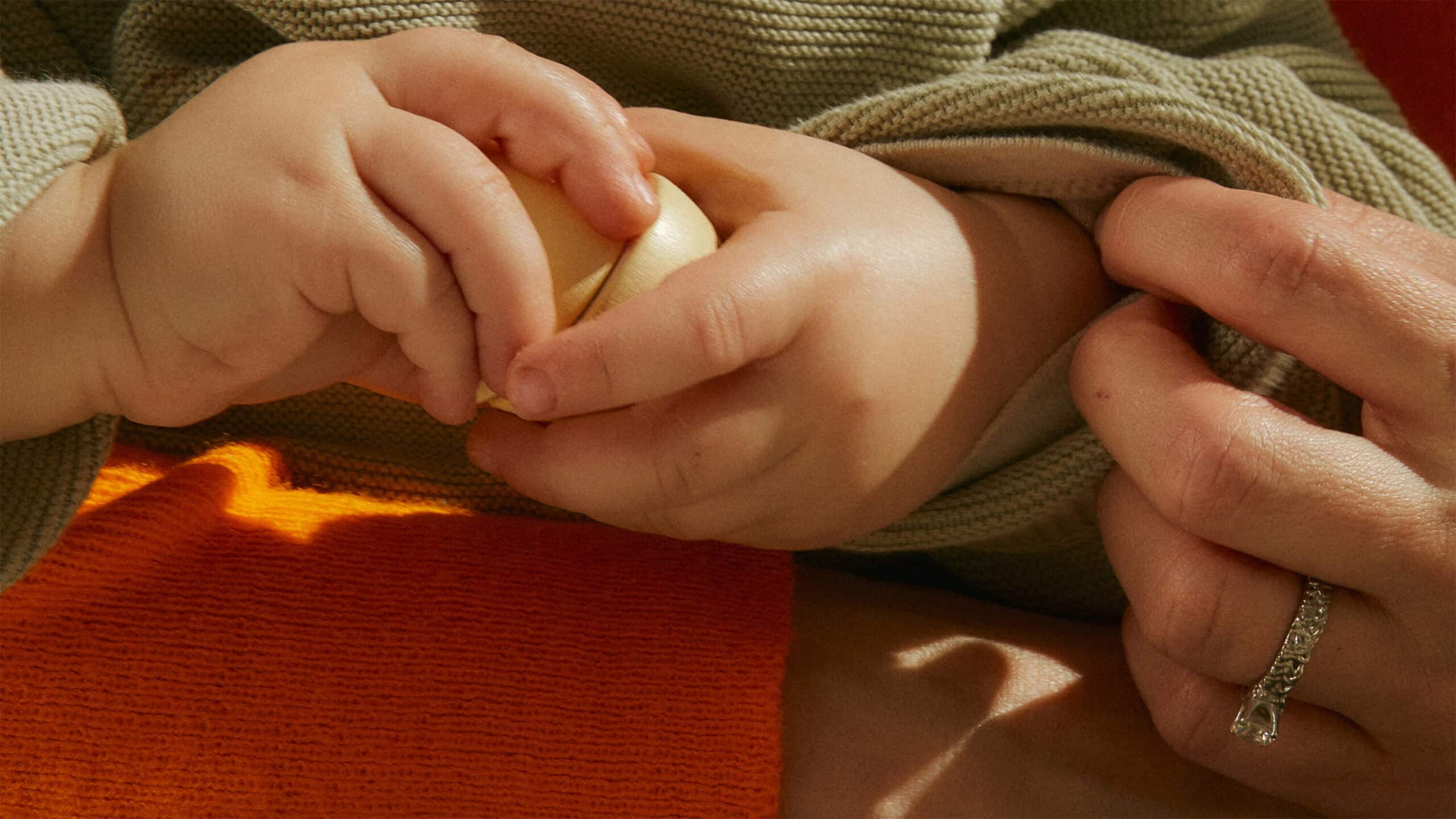 Baby holding apple slice